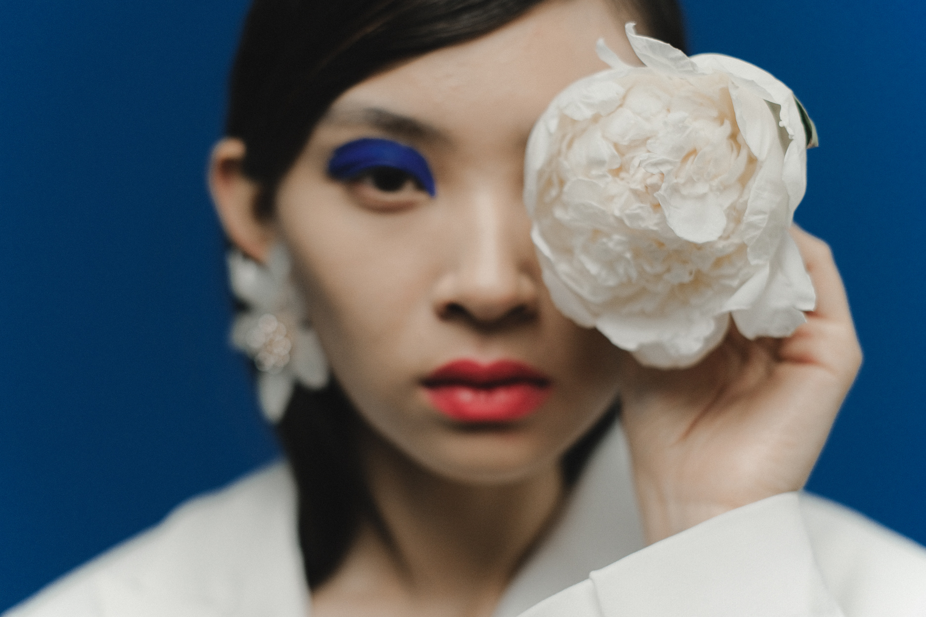 A Woman Holding a White Flower