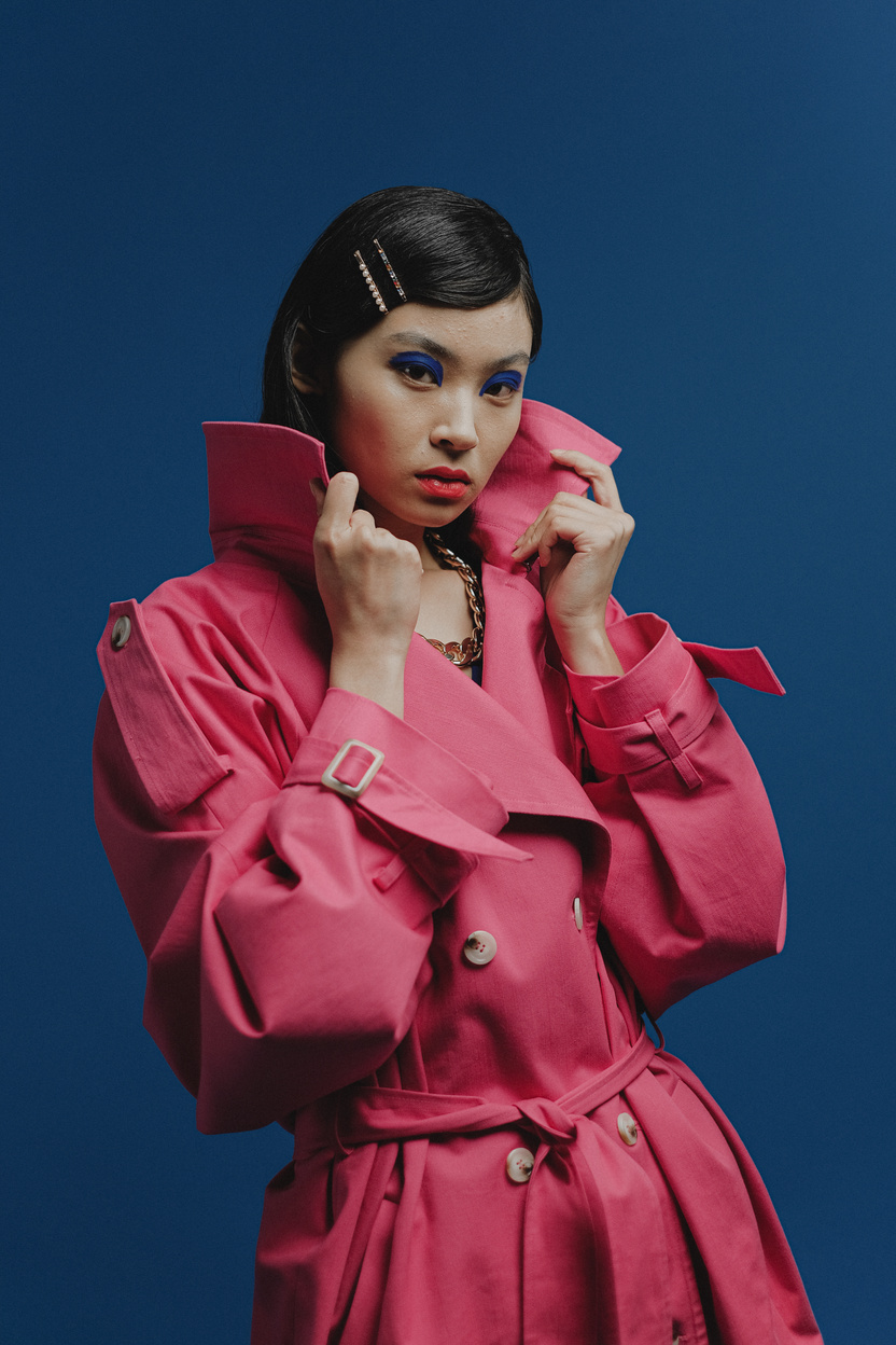 Woman in Red Coat Wearing Black Headphones