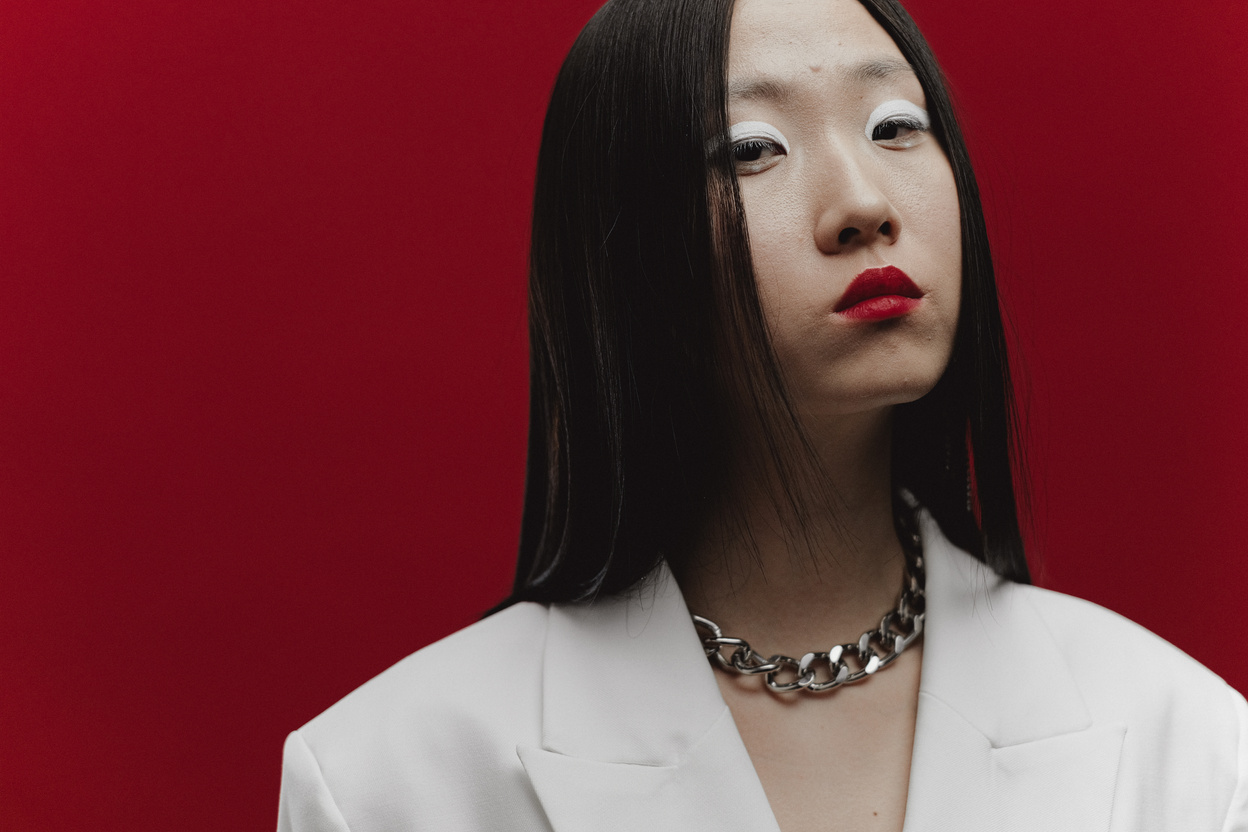 Woman in White Blazer With Silver Necklace